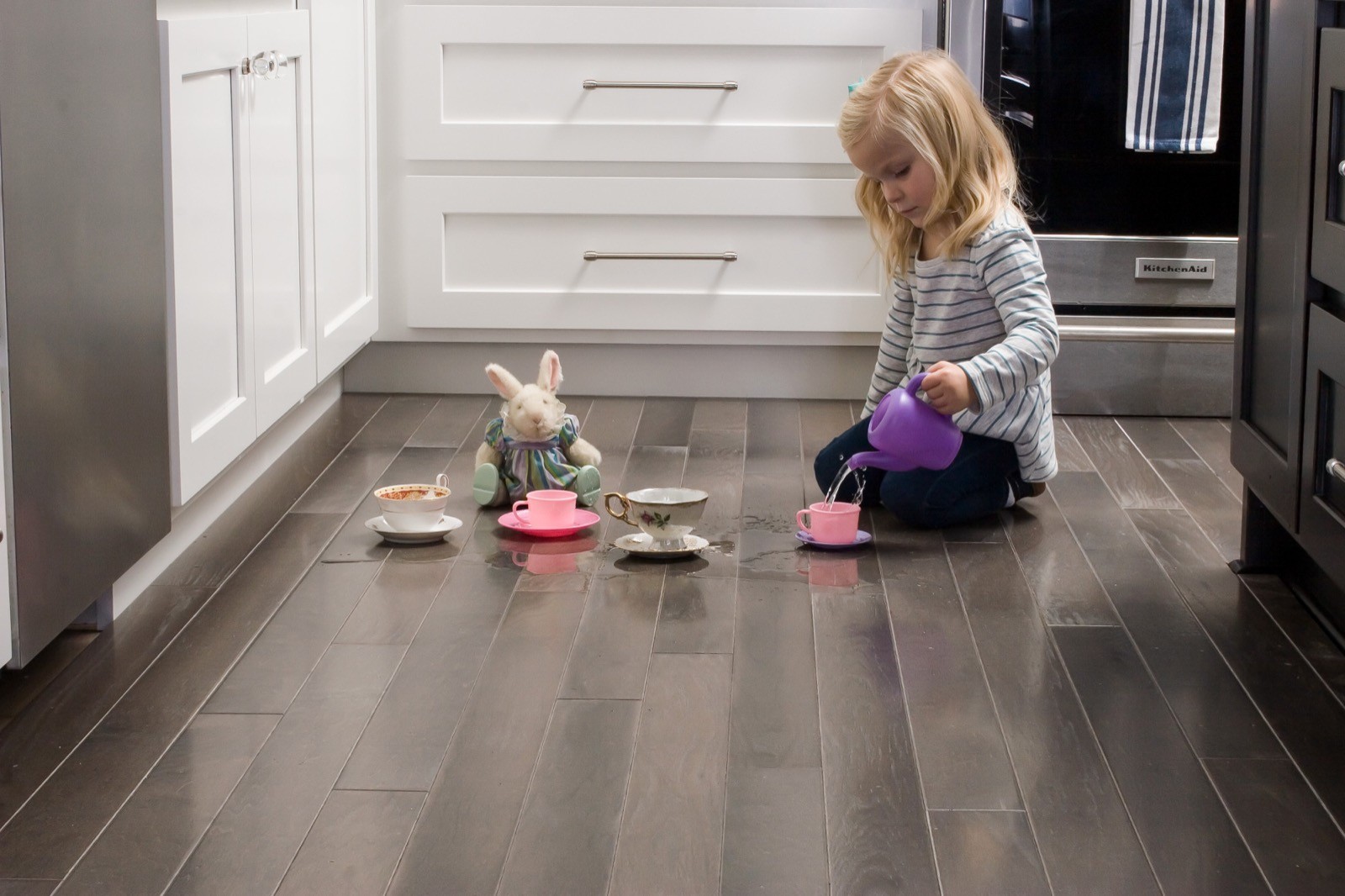 girl playing on kitchen floor