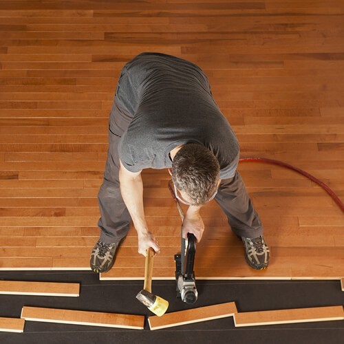 Man installing hardwood flooring