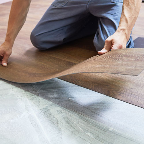 Professional installing luxury vinyl plank in Miami, FL home